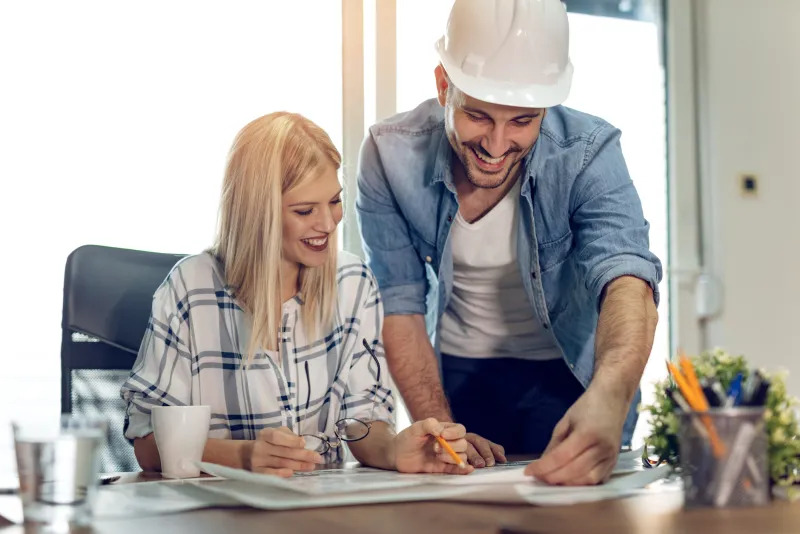 Contractor reviewing paperwork with client