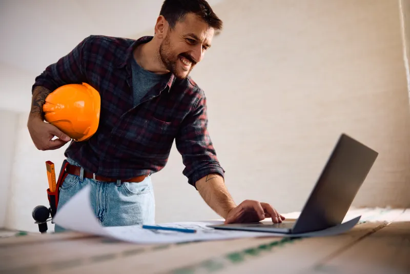 Professional contractor using painting quote software on computer